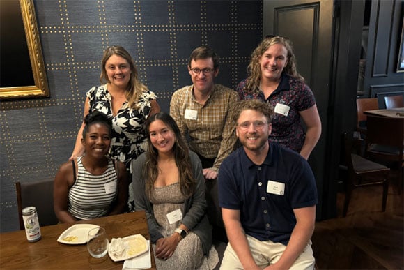 Alumni at an event posing for a picture.