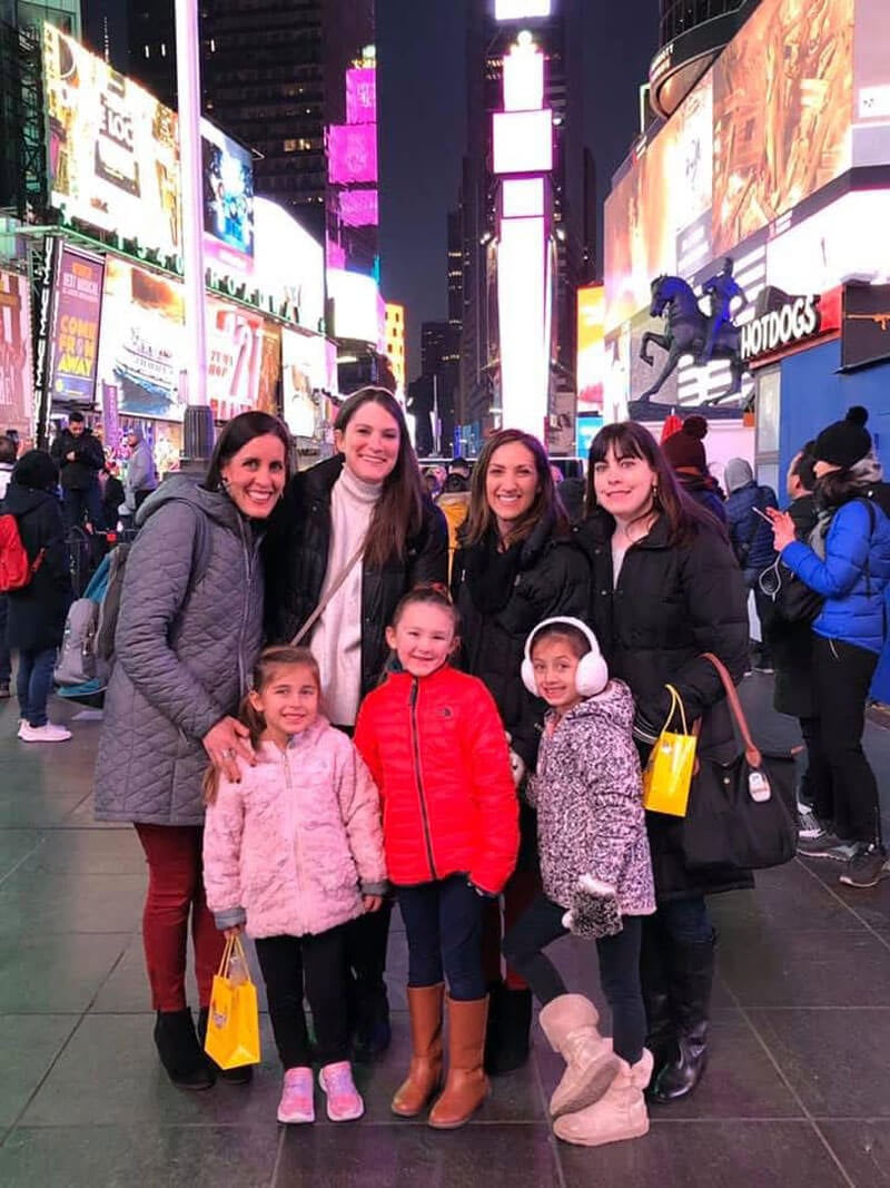 Quinnipiac alumni Meghan Witheril, Katie (Koproski) Mattice, Deena (DeLucia) Scigliano, and Christina Fink pose for a picture with their kids in New York City
