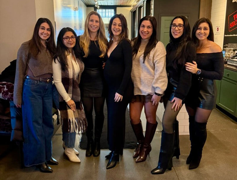 Quinnipiac alumna Jessica Grace poses for a picture with several of her alumnae friends