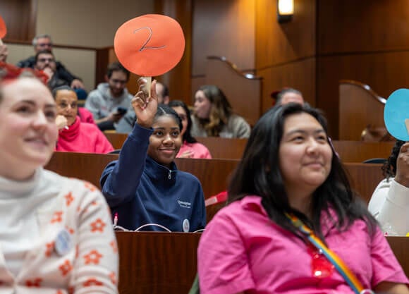 Individuals participate in the School of Law Public Interest Law Project annual auction.