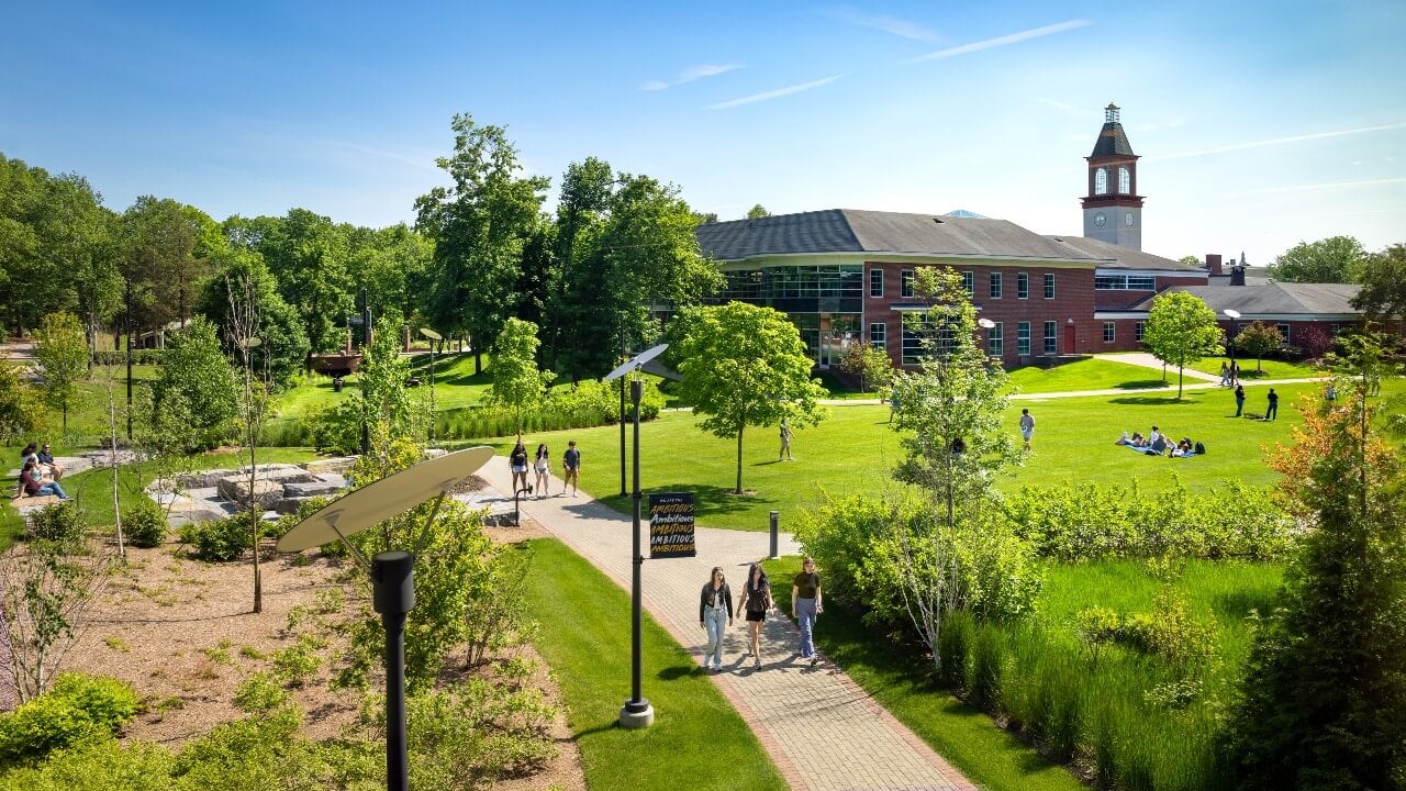 Students walking across campus on a sunny day