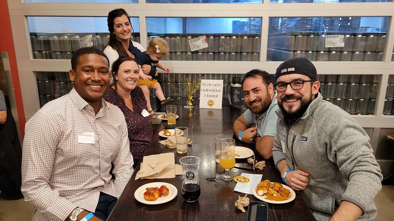 A group of alumni sitting at a table together