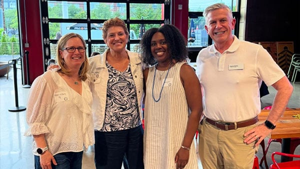 Quinnipiac alumni pose for a picture during an event.
