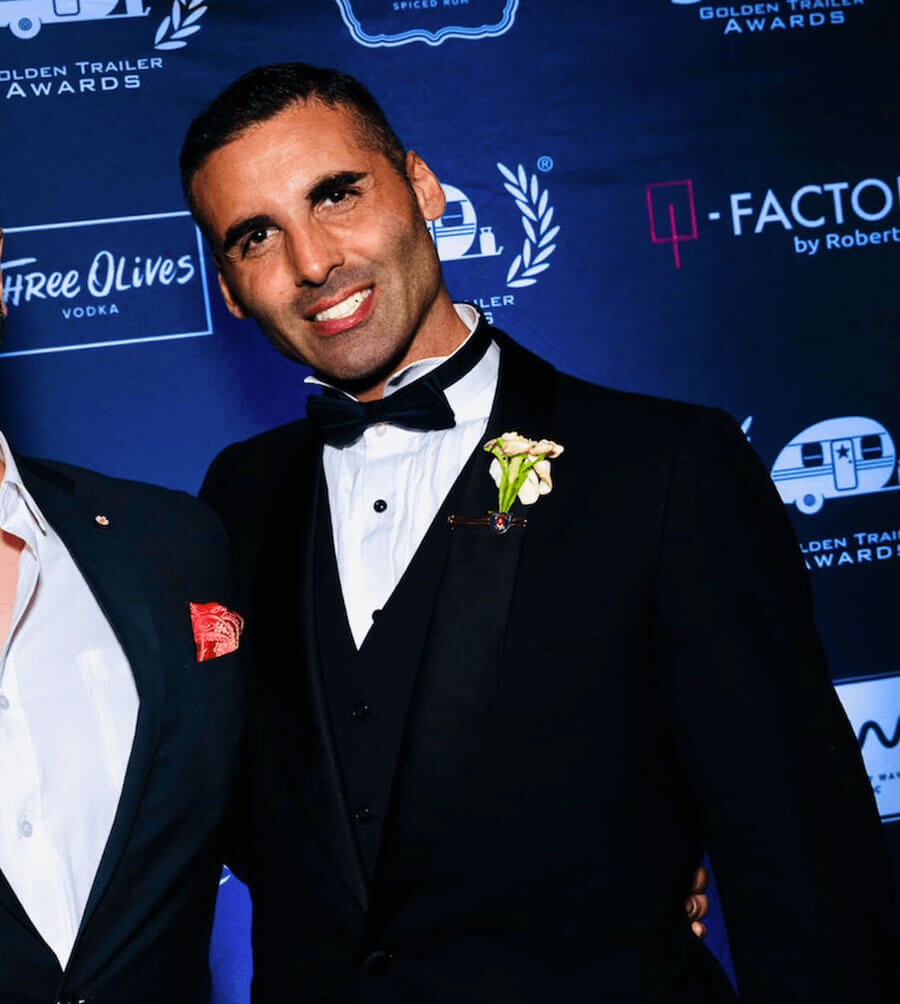 Brendan Amoruso in a tuxedo posing for a photo