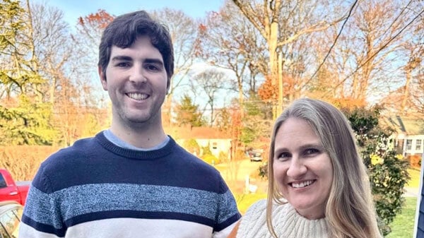 Alex and Eileen Bernstein smile together with their newborn baby