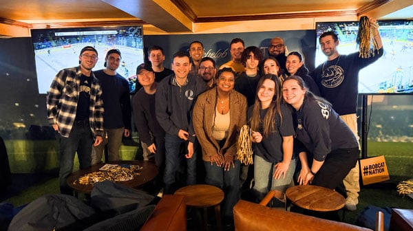 Quinnipiac alumni celebrating during an ice hockey pregame reception.