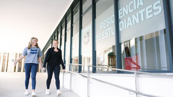 2 female students walking outside