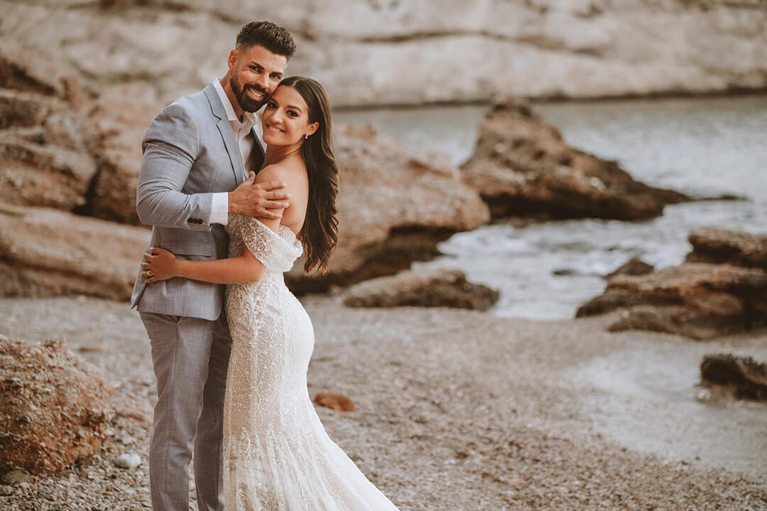 Alex Rigazio and Alexis (Smith) Rigazio pose cheek to cheek on the beach on their wedding day