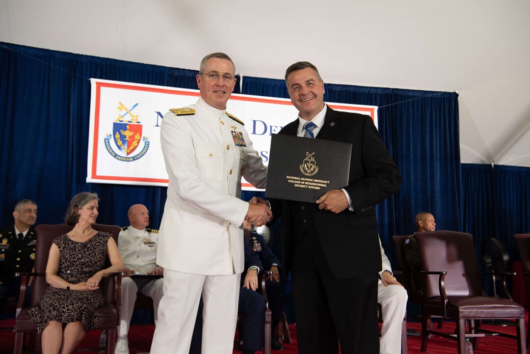 Jeremiah	Cottle in his military uniform receiving his diploma from National Defense University