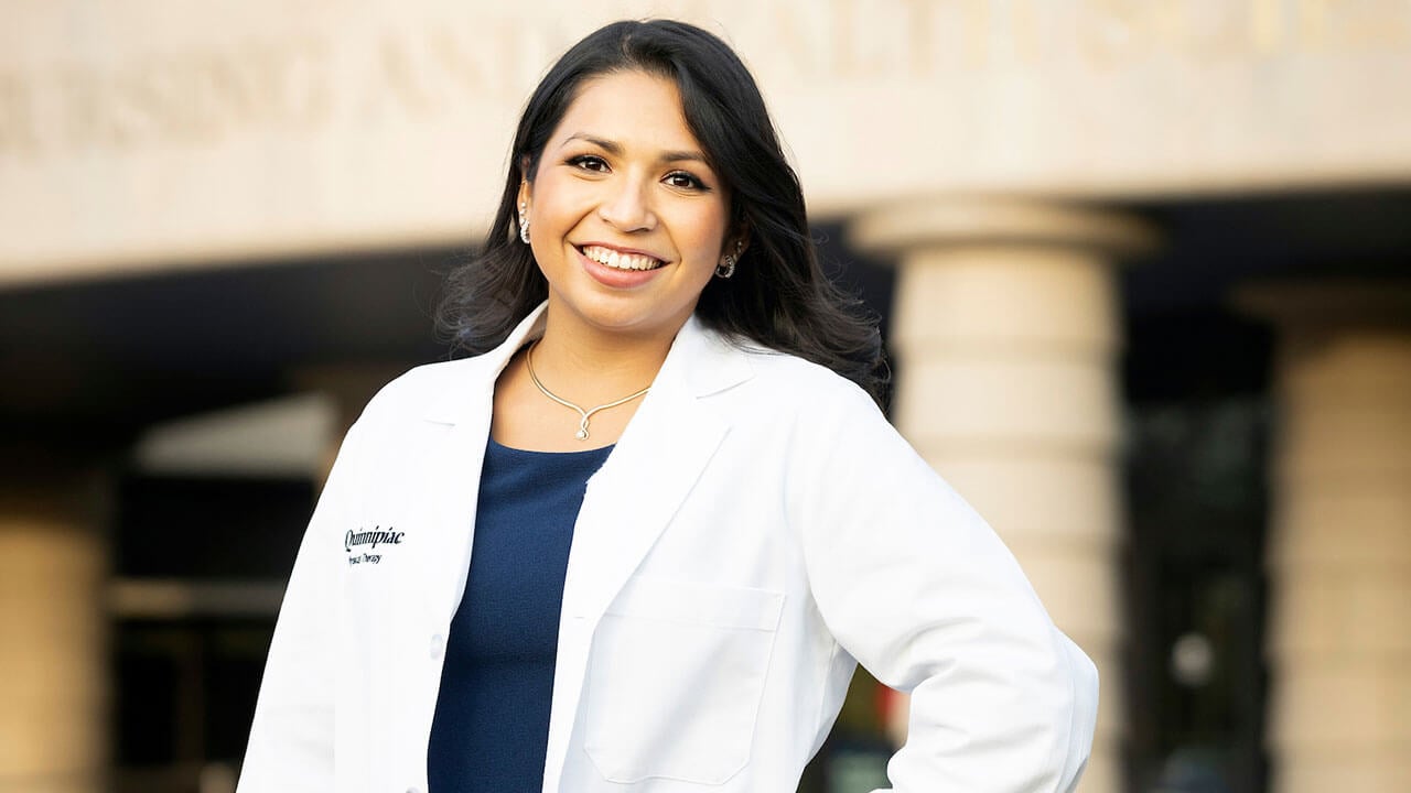 Nicole Mawhiter wears a white coat outside at the North Haven Campus