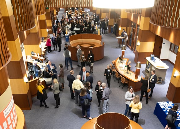 Dozens of alumni network during a reception on the North Haven Campus